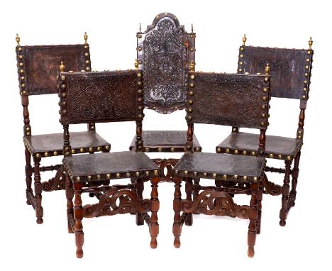 Harlequin set of four Continental 17th century-style oak and tooled leather dining chairs, each with square brass close butto