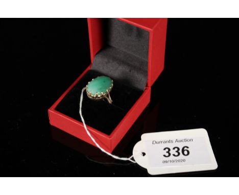 A yellow metal ring set with oval jade stone, size M 1/2, weight approx 7g
