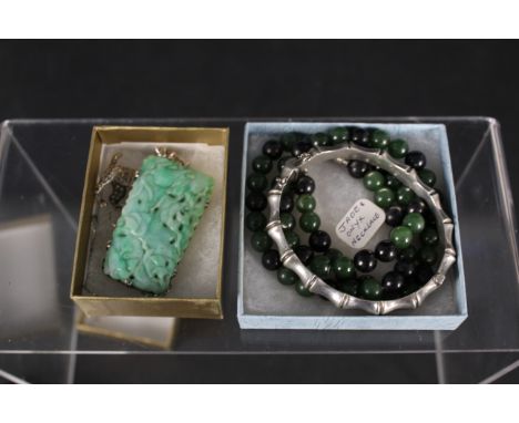 Mixed jewellery to include a carved jade brooch mounted in white metal, a silver bamboo effect bangle, a white metal marcasit