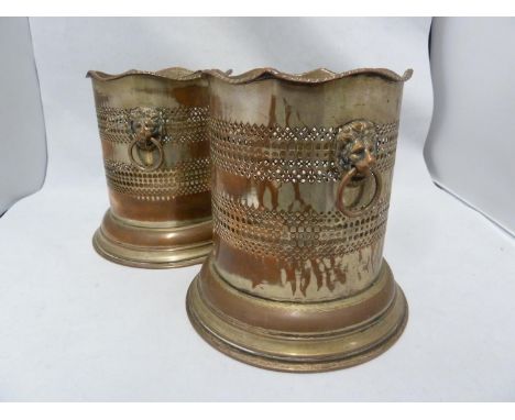 A pair of silver plated on copper Champagne bottle stands, with lion head ring handles, 16cm high (2) 