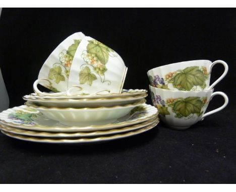 A Royal Worcester porcelain dinner service, of Vine Harvest Pattern, on Warmstry Shape the design of a garland of white and r