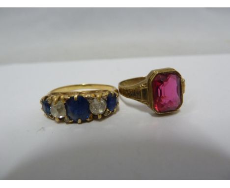 An 8ct yellow gold ring, set with a red stone, possibly a garnet, inscribed to shoulders and internally marked 333, ring size