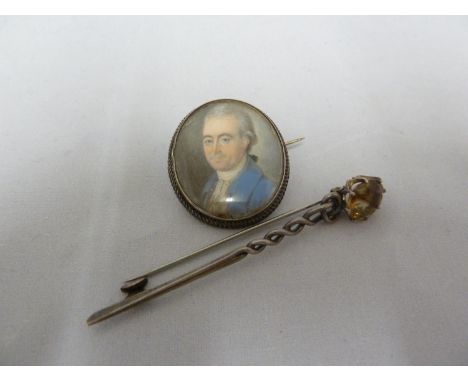 Scottish Interest - a white metal plaid pin, set with a Cairngorm stone, 8cm max; and a portrait miniature of a Scottish gent