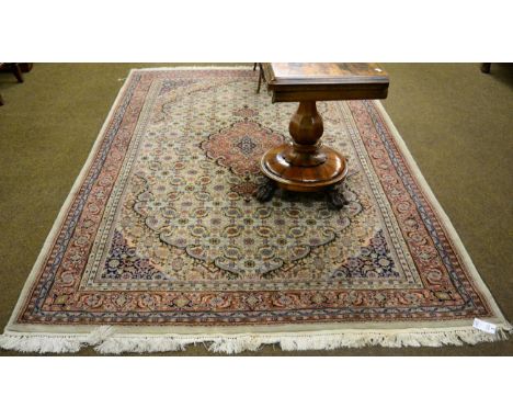 An Indian carpet, the cream Herati field with central medallion framed by samovar motif borders, 272cm by 184cm 