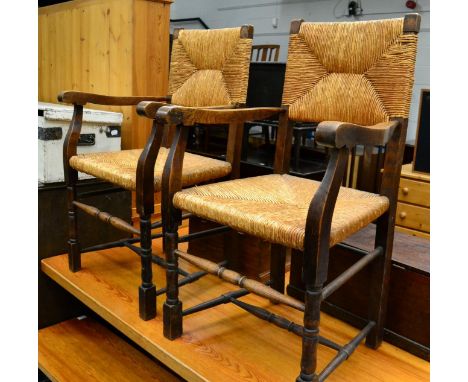A pair of Arts & Crafts oak and rope work elbow chairs together with a mid 20th century leather stool 