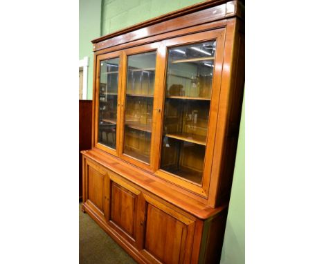 A light mahogany glazed bookcase the base with three doors