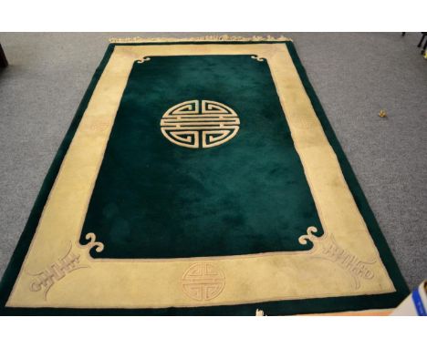 Chinese carved carpet, the emerald field with central roundel enclosed by cream borders, 276cm by 180cm 