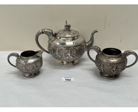 An early 20th century Burmese 800 silver tea service, comprising teapot, sucrier and milk jug, with elephant head handles and