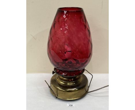 An oillamp with ruby glass shade. 17½' high. Converted to electric light