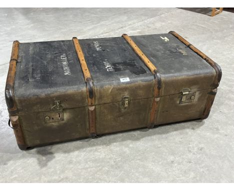 A vintage canvas and wood bound cabin trunk