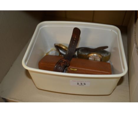 A box containing four various wrist watches; an Ipswich bike club medal with enamel decoration