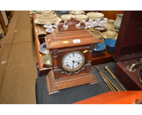 A late Victorian oak cased two hole mantel clock