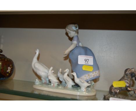 A Lladro figurine in the form of a young girl with ducks