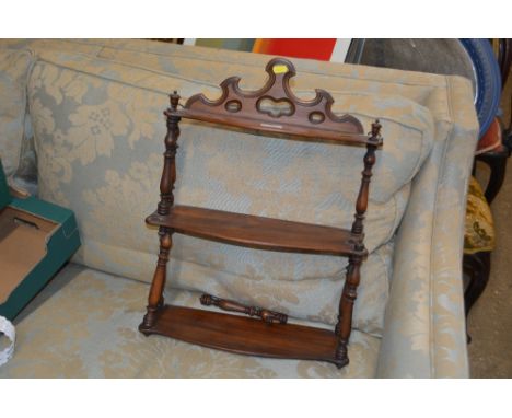 A mahogany three tired wall shelf