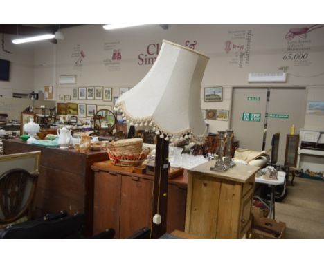 A carved mahogany standard lamp and shade
