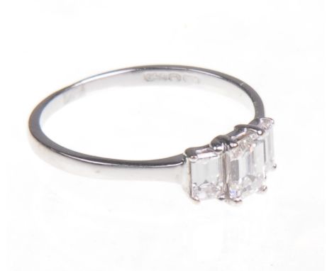 An 18ct white gold diamond three stone ring
Set with three emerald cut diamonds, ring size J½, 1.9gms, in a Profile jewellery