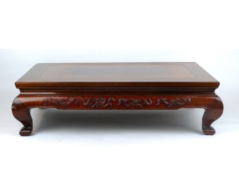 A Chinese Huanghuali style miniature 'Kang' table 
The carved hardwood stand or table, with typical inset rectangular top and