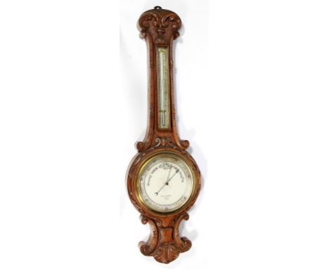 A Victorian carved oak banjo barometer
Retailed by Negretti & Zambra London, heavily carved with scrolls and foliate, length 