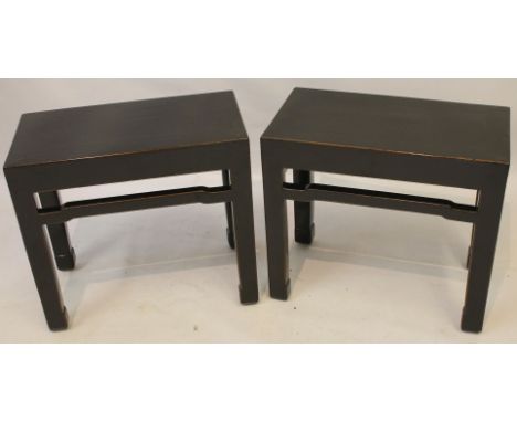A pair of Chinese black lacquered huanghuali style stools or occasional tables
Each of the rectangular tops extending to stra