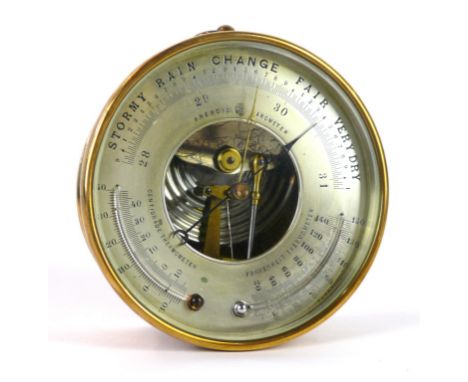 A circular brass aneroid barometer 
The movement fitted in a brass outer case, length 14cm

