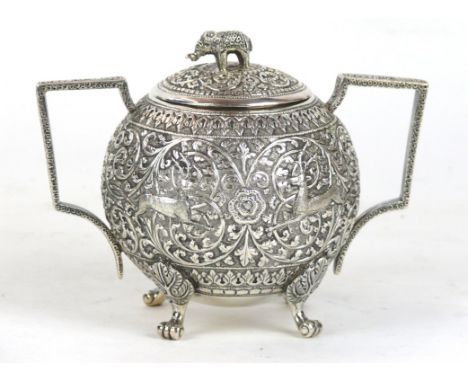 An Indian silver lidded sucrier, possibly Kutch, Circa 1900 Of globular form, raised on four paw feet, flanked by arched twin