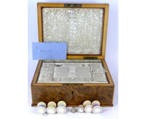 A Victorian burr Walnut sewing box
The cover inlaid with Anne Walker 1860, enclosing mother of pearl and silk fitted interior