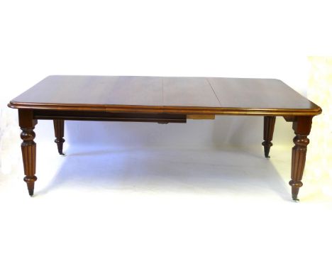 A Victorian mahogany wind action extending dining table, two leaves and winder
The rectangular top with rounded corners and d