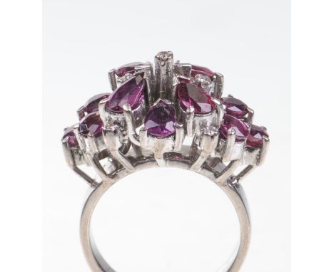 A ruby and diamond set cocktail ring, circa 1970
Set with marquise cut rubies within a lozenge shaped cluster, with tiny diam