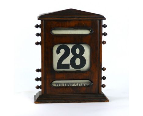 A 1920's oak cased calendar mantel clock
of Gothic form with arched top, height 29cm.
