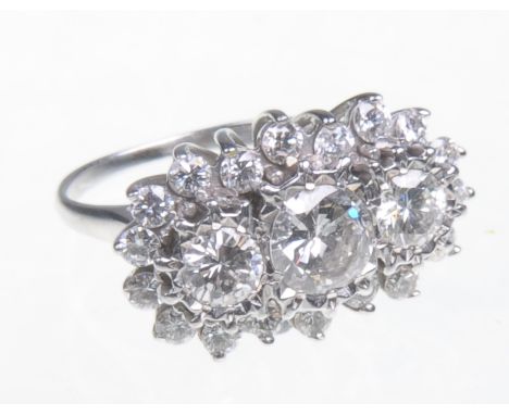 A fine 18ct white gold diamond cluster ring
Featuring a central round cut diamond of approximately 1ct, flanked by two furthe