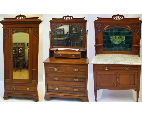 A good quality Edwardian carved walnut three piece bedroom suite in the Art Nouveau style
Comprising a wardrobe with stylised