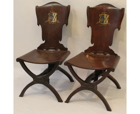 A pair of elegant Georgian-style mahogany hall chairs, probably 18th Century
The carved scrolled and shaped backs painted wit