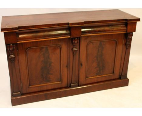 A Victorian feathered mahogany breakfront chiffonier
The two curved moulded frieze drawers over hanging two panelled cupboard