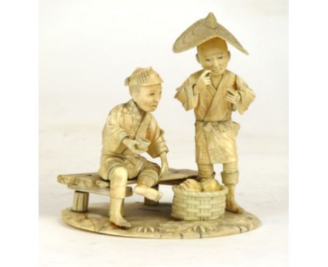 A Japanese carved ivory Okimono figure group, Meiji Period (1868-1912)
Depicting two elderly gentleman seated on or before a 