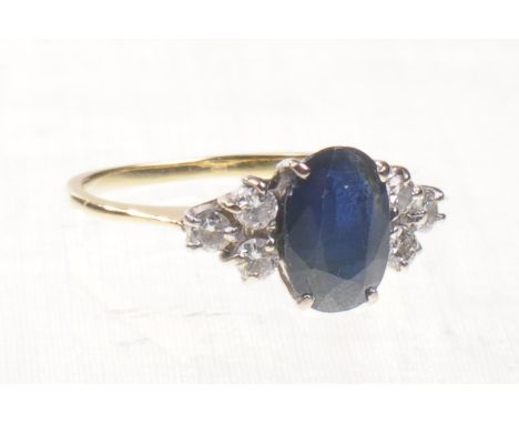 A sapphire and diamond set dress ring
The central oval mixed cut sapphire of approx 9x6mm four claw set to three round brilli