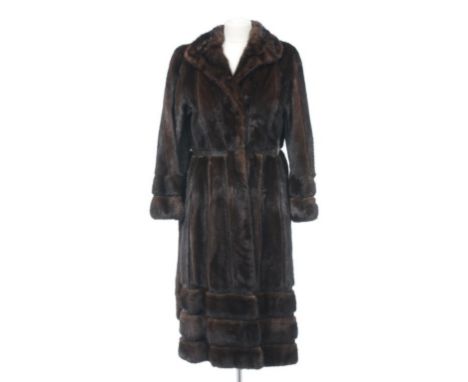 A fine quality mink and leather ladies full length coat, Circa 1970s 
The waisted and tailored full length coat with detachab