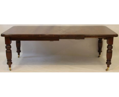 A Victorian wind action walnut extending dining tables, with two extra leaves
The rectangular top with rounded corners and mo