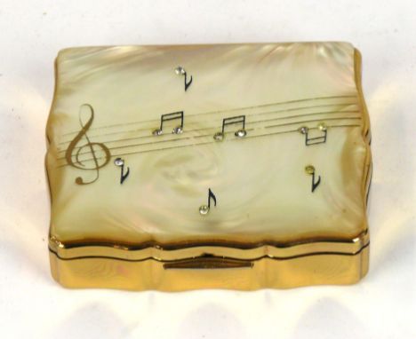 A 1950's Stratton musical compact
Modelled with a faux mother of pearl cover with inlaid music notes, enclosing a mirror and 