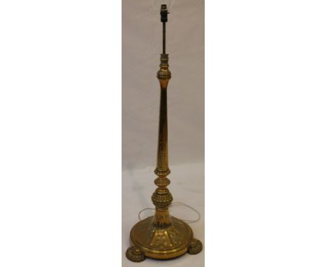 An early 20th Century brass adjustable standard lamp
The spreading octagonal and circular column embossed and chased with sty