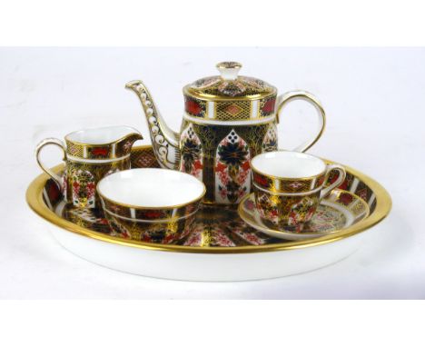 A Royal Crown Derby miniature five piece tea service decorated in pattern number 1128
Comprising teapot, milk jug, sugar bowl