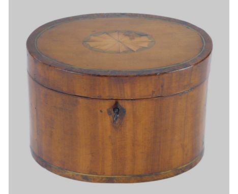 A Regency inlaid satin wood and burr walnut oval tea caddy
The cover inlaid with an open shell, enclosing a burr walnut inter