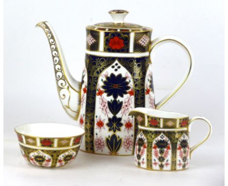 A Royal Crown Derby three piece tea service decorated in pattern number 1128
Comprising teapot, milk jug, sugar bowl, printed