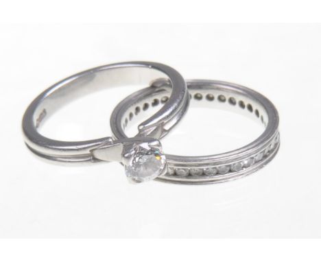 A diamond and platinum single stone ring, together with a diamond eternity ring
The single stone ring with a round cut diamon