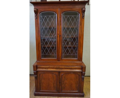 A good quality Victorian mahogany tall library bookcase
The moulded overhanging cornice above two leaded light and glazed pan