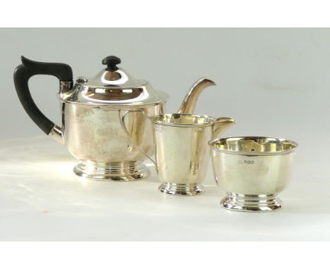 An Edward VIII hallmarked silver three piece tea service
Comprising tea, pot, milk jug, sugar bowl, each of circular form, ra