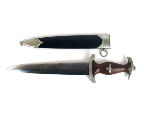 A Nazi Germany S.A. dagger
The 22cm straight double edged blade marked Wagner & Lange Solingen, the wooden grip with eagle an
