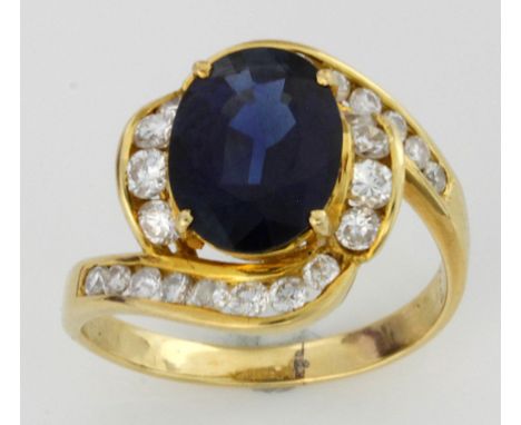 An 18ct yellow gold sapphire and diamond cocktail ring
The central facet cut oval sapphire approx. 11mm long, amidst twenty-f