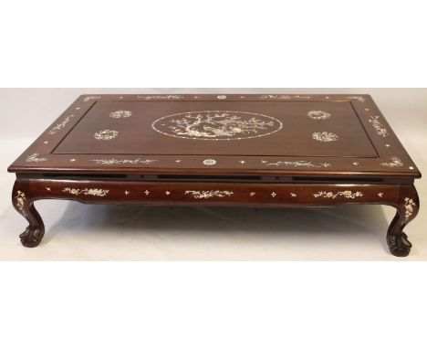 A Chinese hardwood 'Kang' low table
The rectangular topped table extending to a scroll pediment and supported on four short p