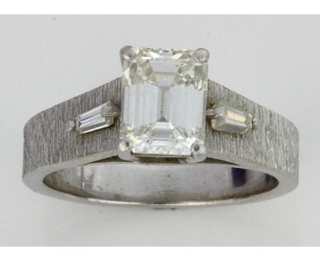 A platinum and 18ct white gold diamond single stone ring
The princess cut diamond approx. 0.75cts, flanked by two baguette cu