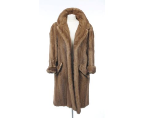 A mink three-quarter length coat, circa 1970s
The pale brown fur coat, with wide collar and lapel and folded pockets, the int